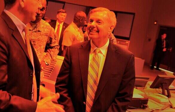 Deputy Secretary of Defense Ashton B. Carter, left, and Senator Lindsey Graham (SC) chat as they visit a mock air traffic control facility with red, subdued lighting, as they visit Joint Base Charleston for briefings on space and naval warfare systems in Charleston, S.C., June 18, 2012. (DoD Photo By Glenn Fawcett) (Released)